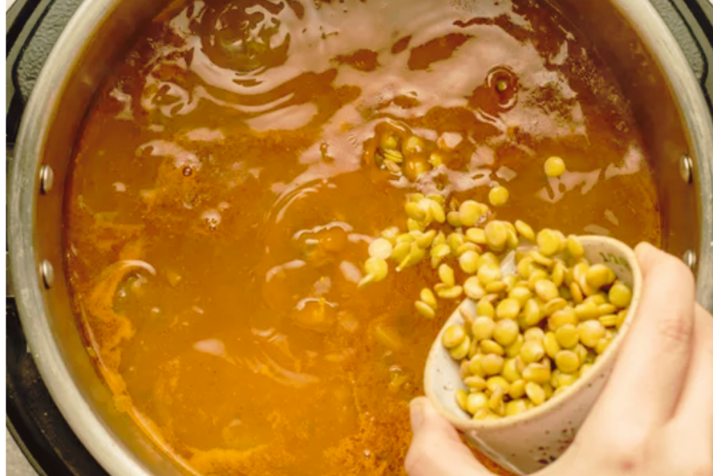 Moroccan harira soup simmering with lentils and tomato paste in pressure cooker