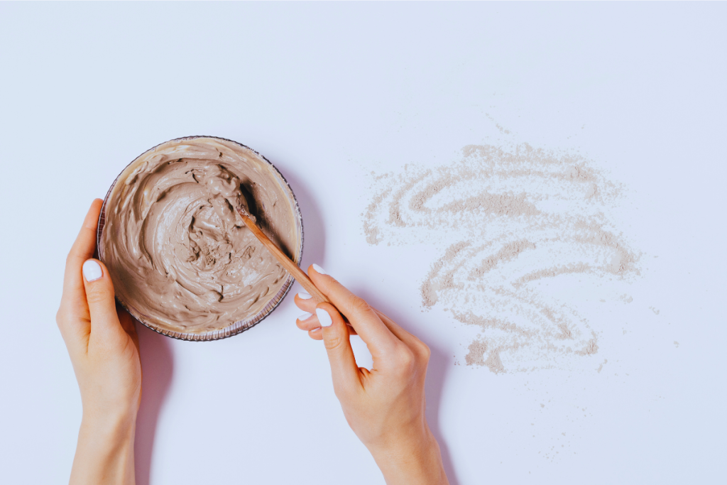 Mixing Rhassoul clay mask ingredients for facial skincare